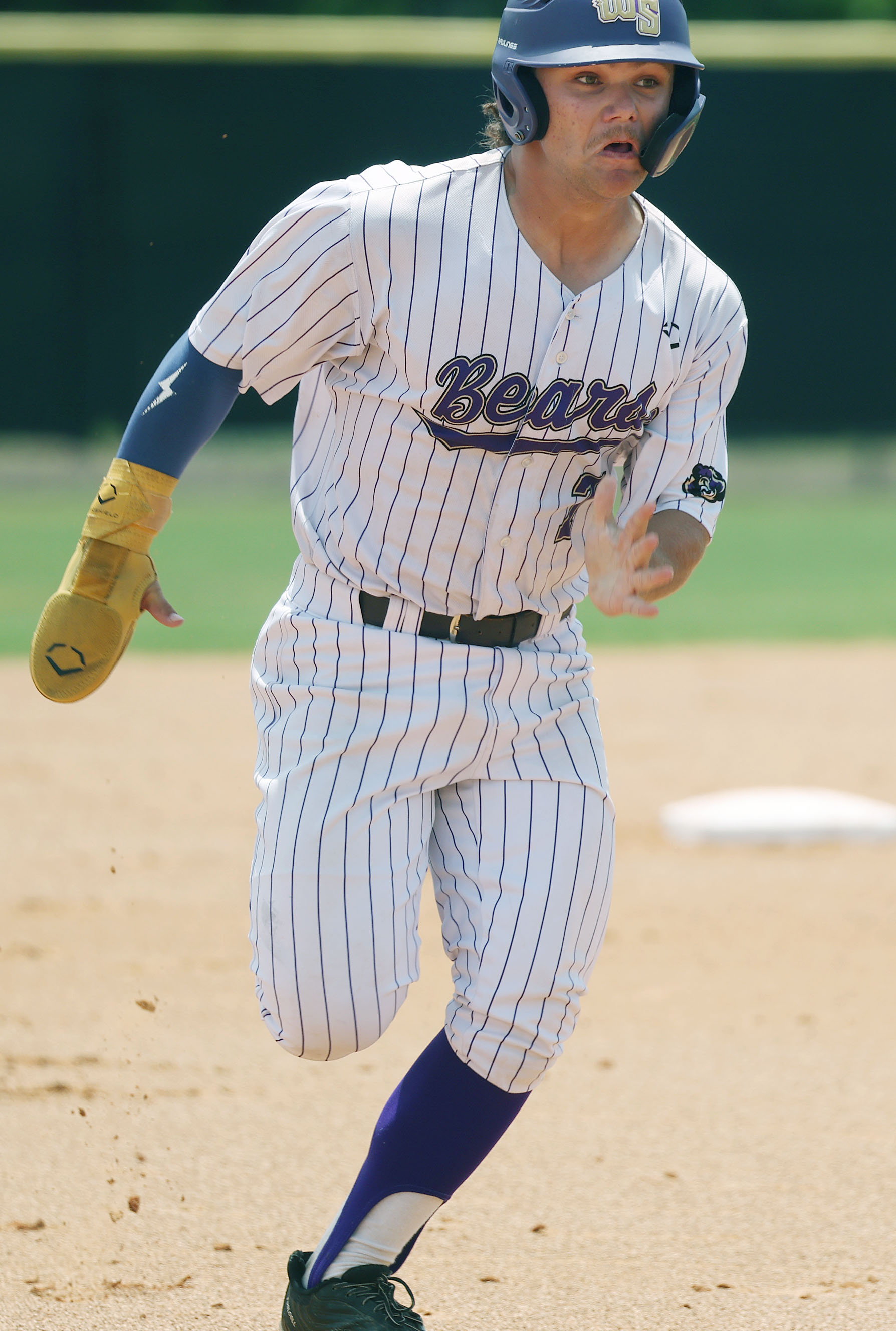 Winter Springs High baseball player Jackson Swann runs to third...