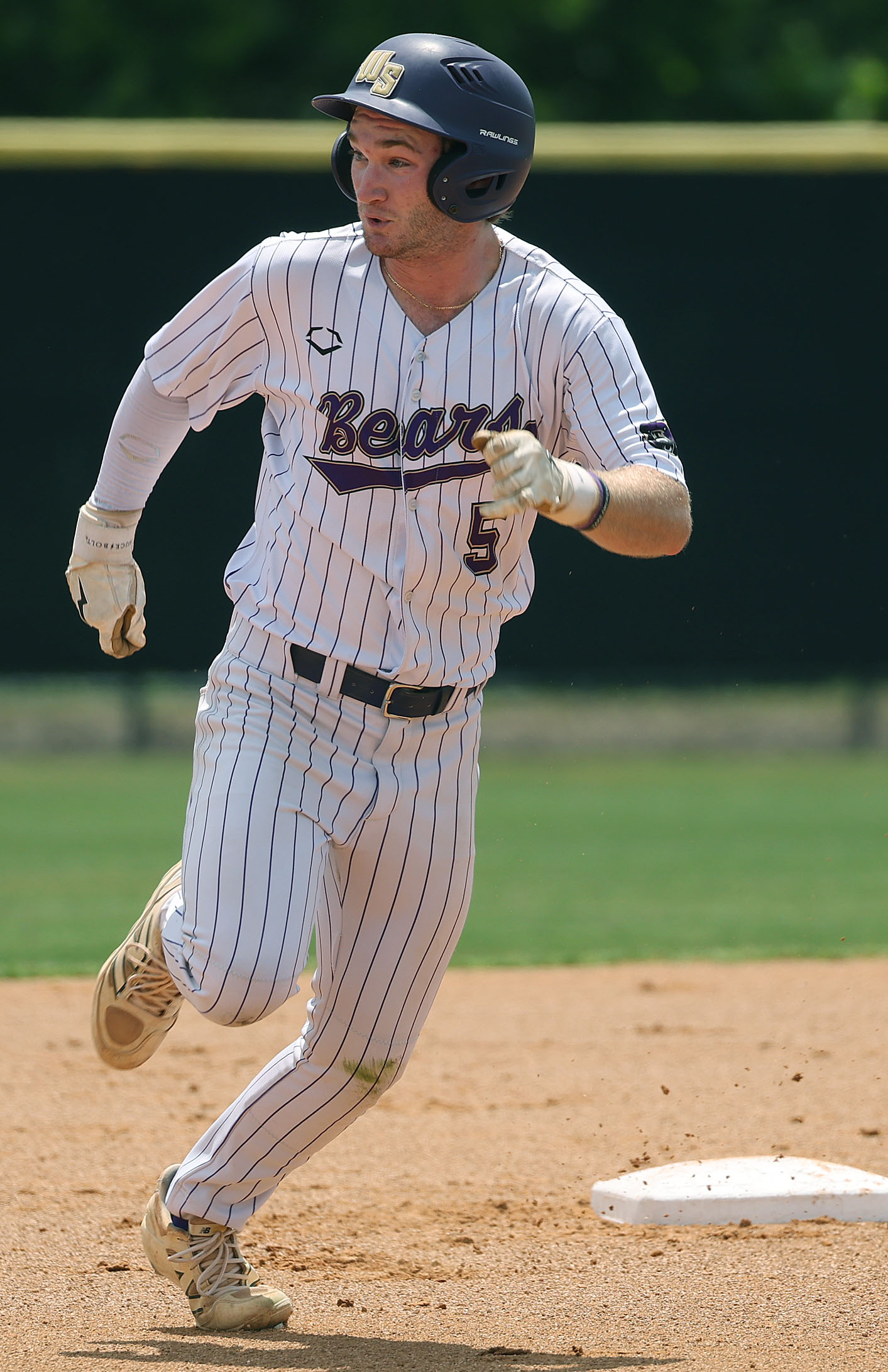 Winter Springs High baseball player Brandon Curl rounds second base...