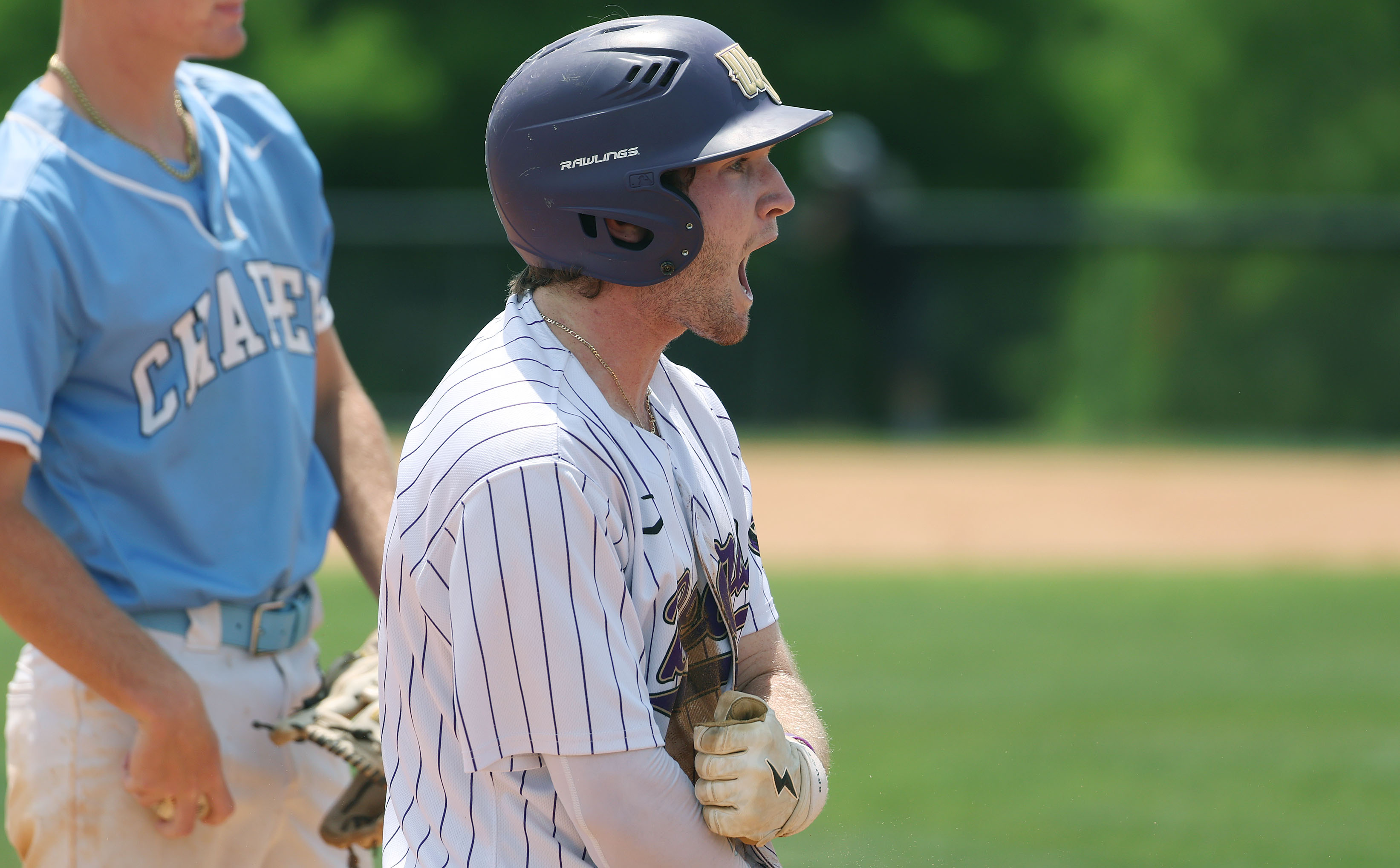 Winter Springs High baseball player Brandon Curl screams in celebratiion...