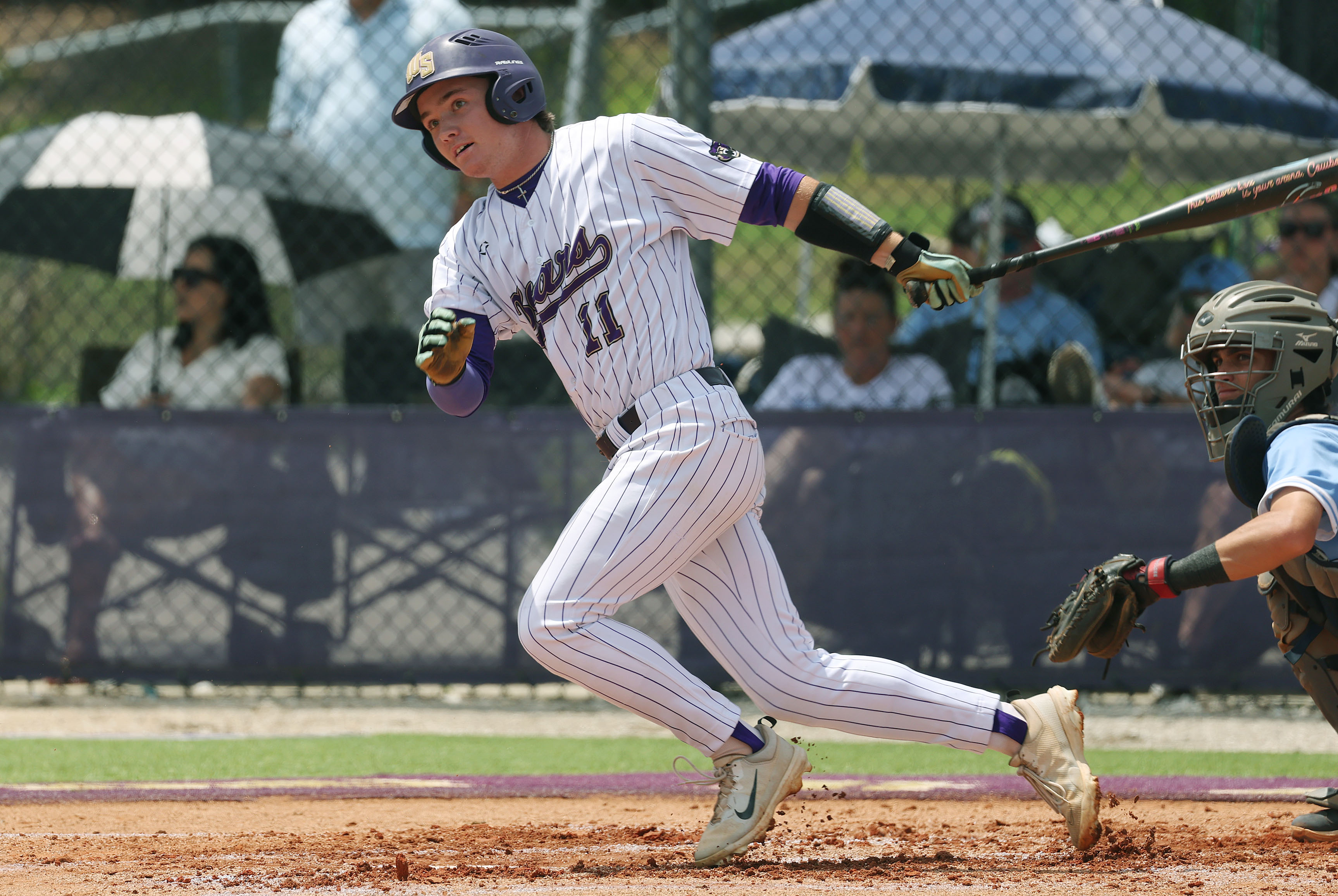 Winter Springs High baseball player Owen Swanson hits during the...