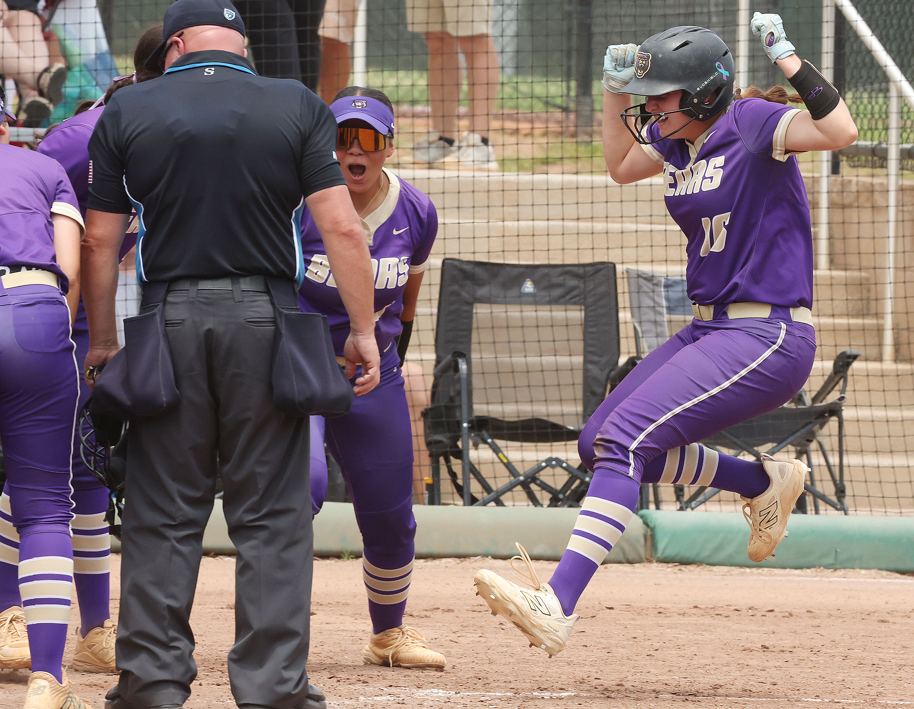 Winter Springs player Abigail Hooper (16) leaps onto home plate...
