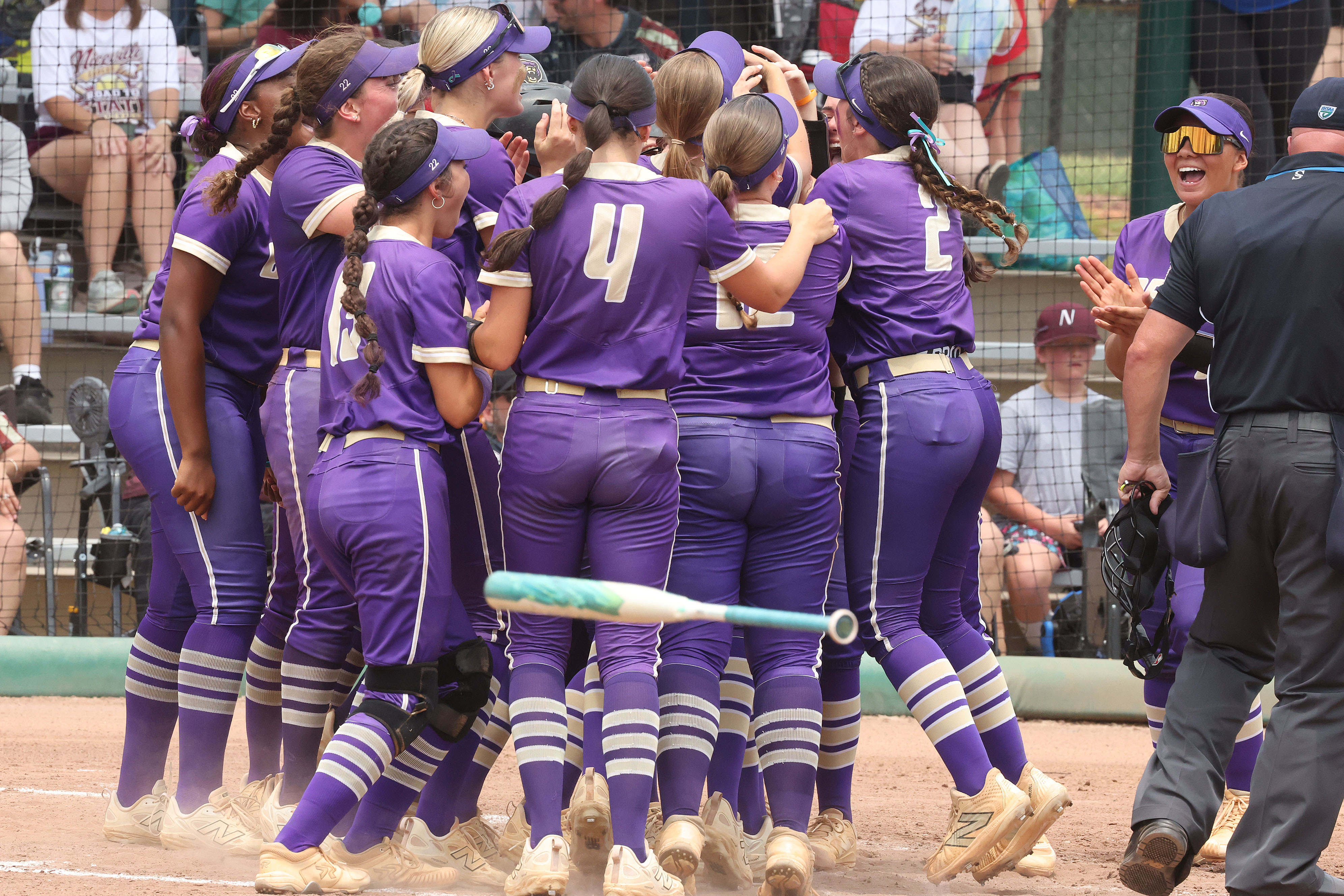 Winter Springs players converge on teammate Abigail Hooper (16) after...