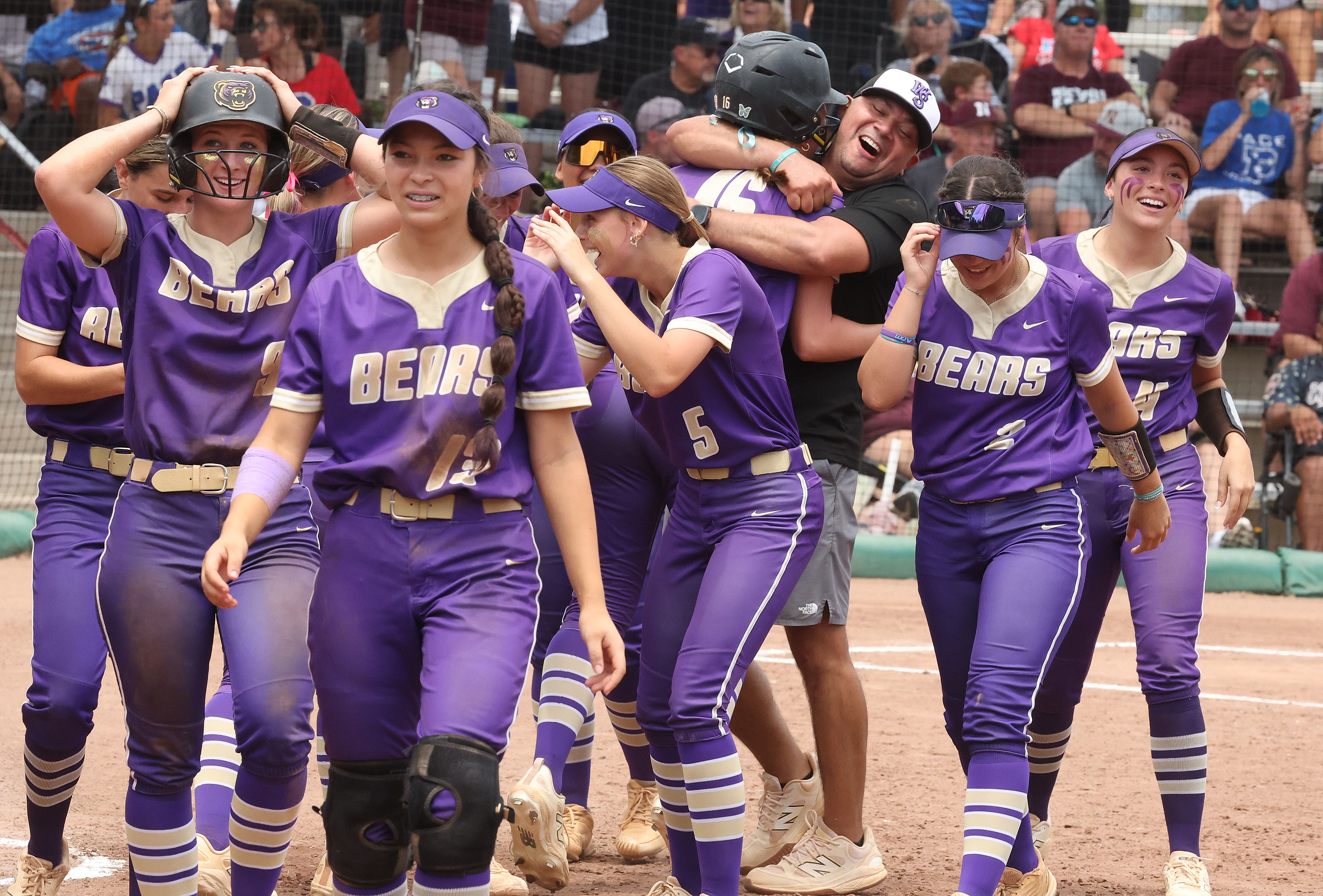 Winter Springs players and coaches converge on teammate Abigail Hooper...