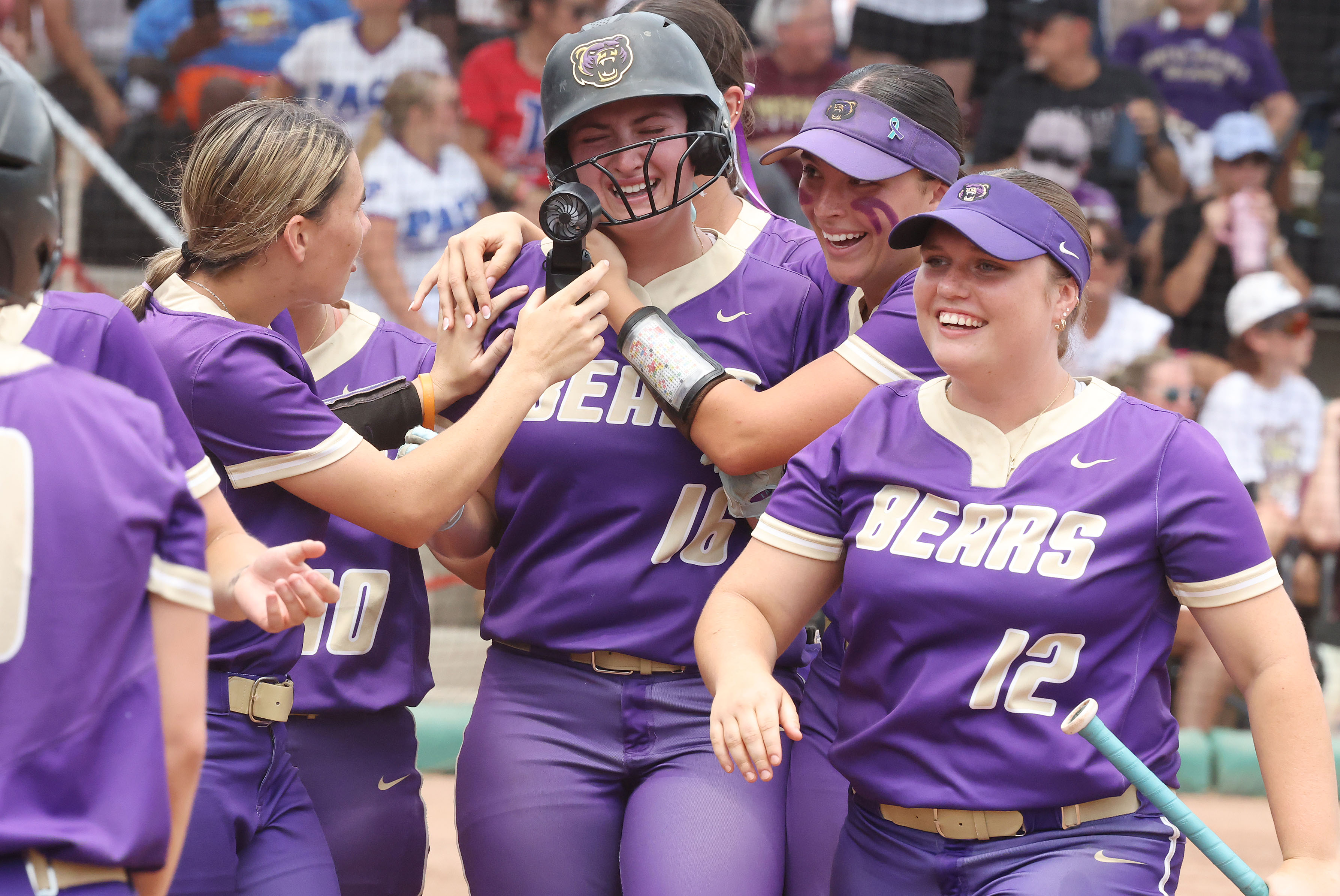 Winter Springs players converge on teammate Abigail Hooper (16) after...
