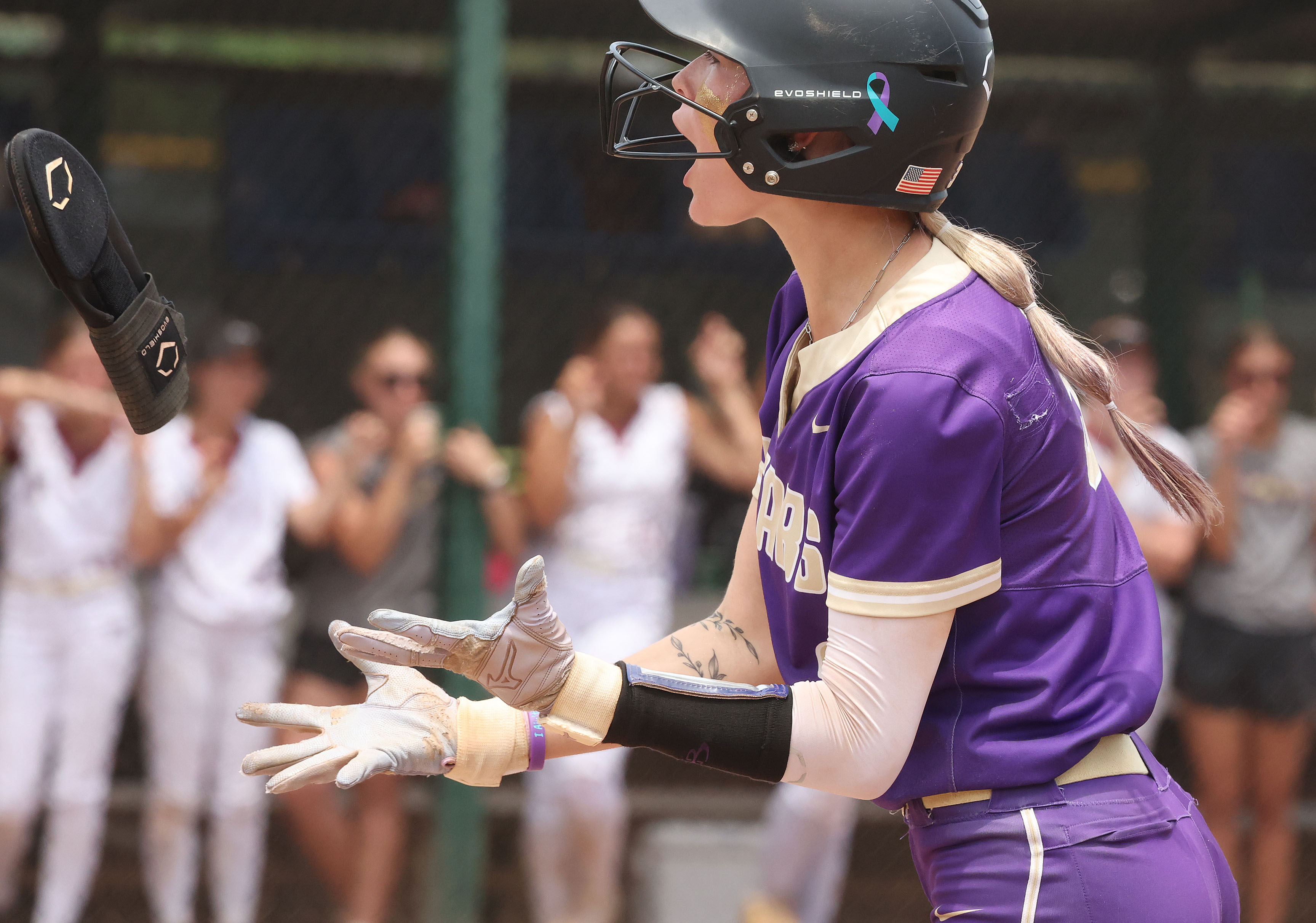Winter Springs player Katelyn Wassey screams after a hit during...