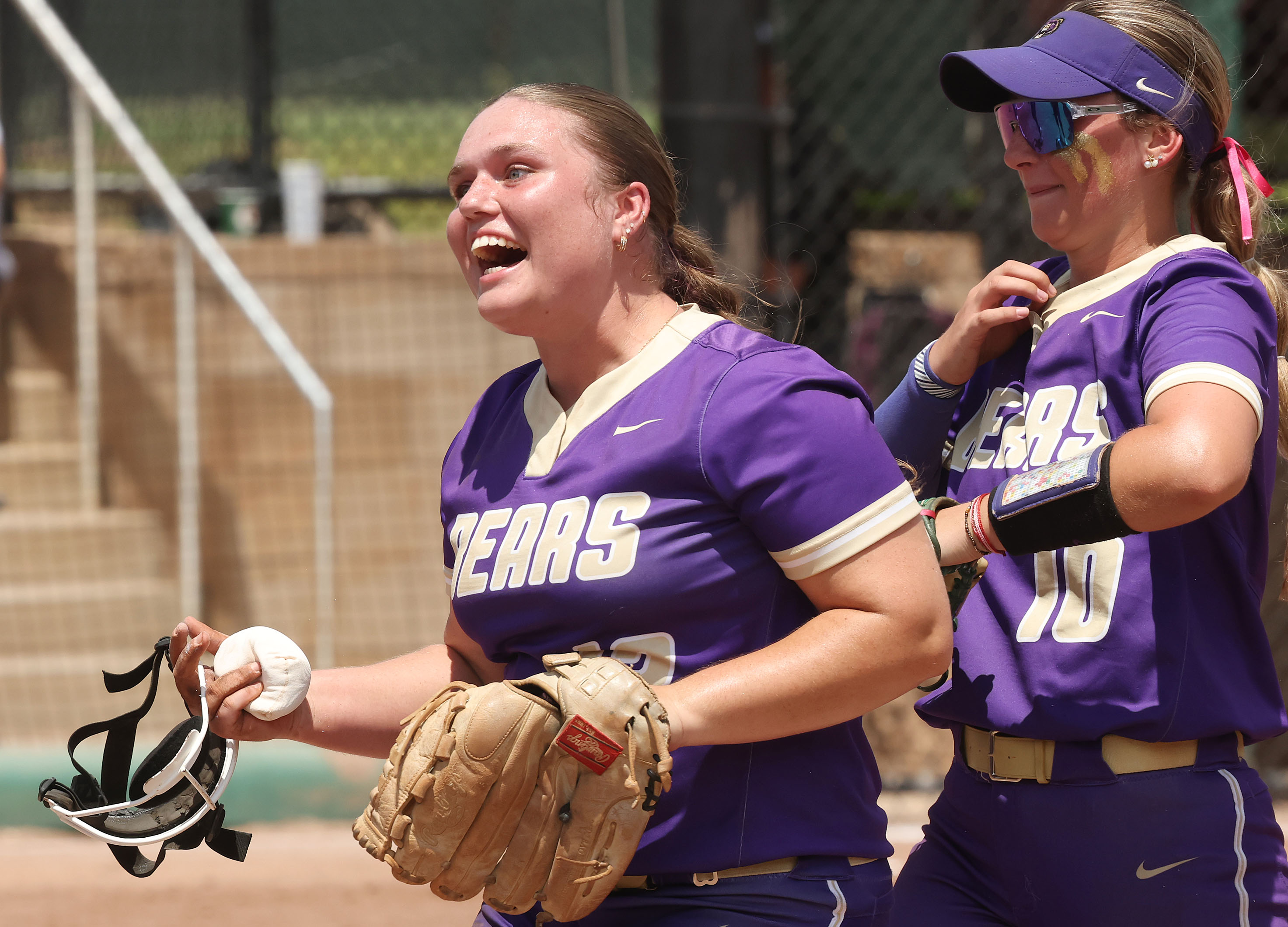 Winter Springs pitcher Christina Brisson (left) celebrates in front of...