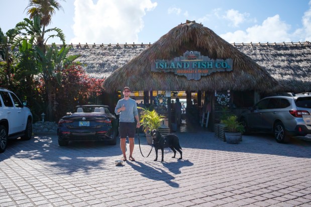 The Island Fish Co. Restaurant and Tiki Bar is a dog-friendly eatery serving up appetizers, seafood, tropical drinks and more in Marathon on April 9, 2026. Patrick Connolly and Leo the black lab approve. (Patrick Connolly/Orlando Sentinel)