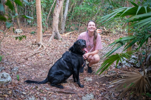 The Curry Hammock Nature Trail takes visitors on a 1.7-mile walk that is dog-friendly and features waterfront views on April 9, 2026. Karissa Bellile and Leo enjoy the scenery of the tropical hike. (Patrick Connolly/Orlando Sentinel)