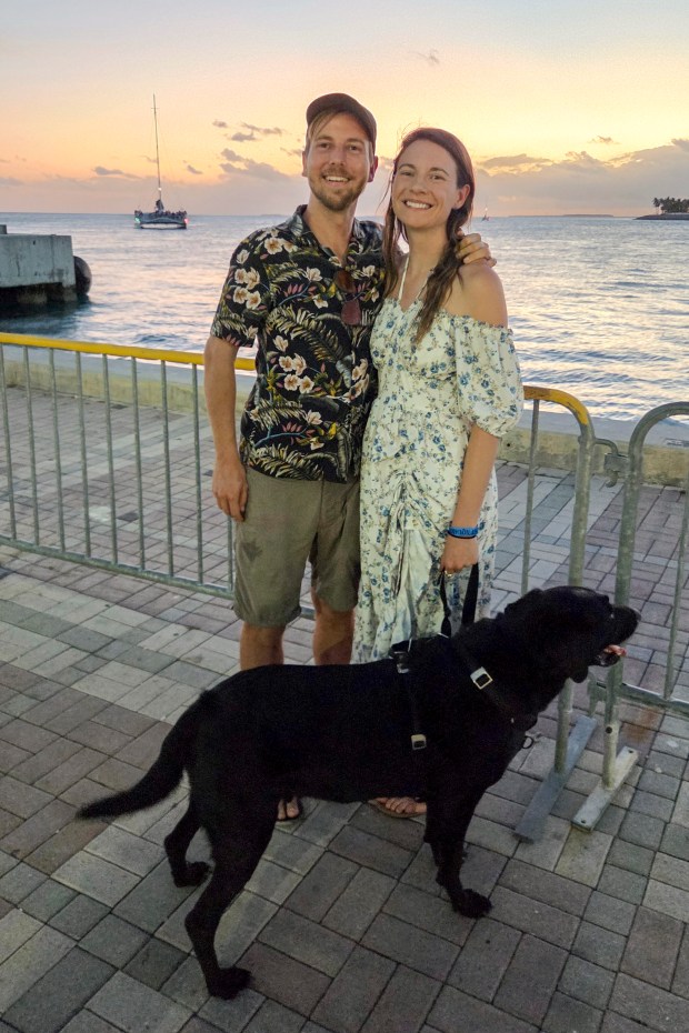 Patrick Connolly, Karissa Bellile and Leo the black lab enjoy the sunset from Mallory Square in Key West on April 10, 2026. (Patrick Connolly/Orlando Sentinel)