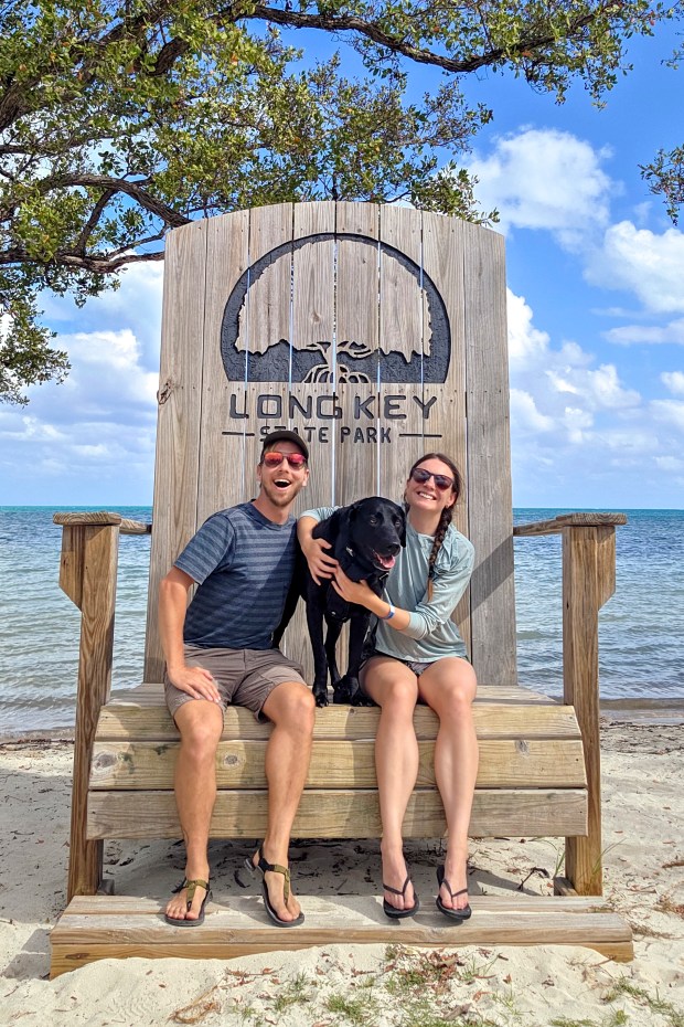 Patrick Connolly, Karissa Bellile and Leo the black lab enjoy a photo op at Long Key State Park on April 11, 2026. (Patrick Connolly/Orlando Sentinel)