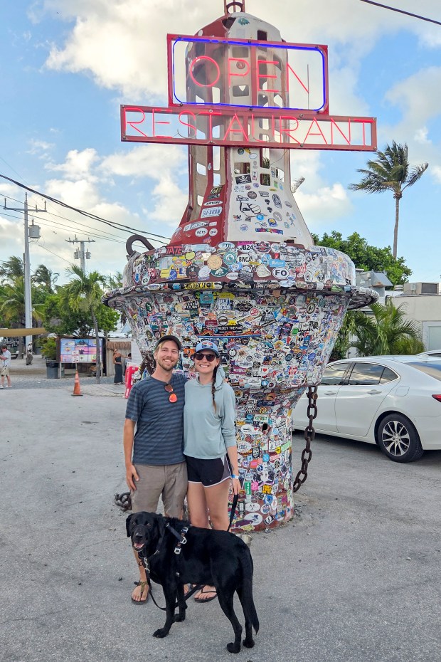 Patrick Connolly, Karissa Bellile and Leo the black lab enjoy a visit to Robbie's of Islamorada on April 11, 2026. (Patrick Connolly/Orlando Sentinel)