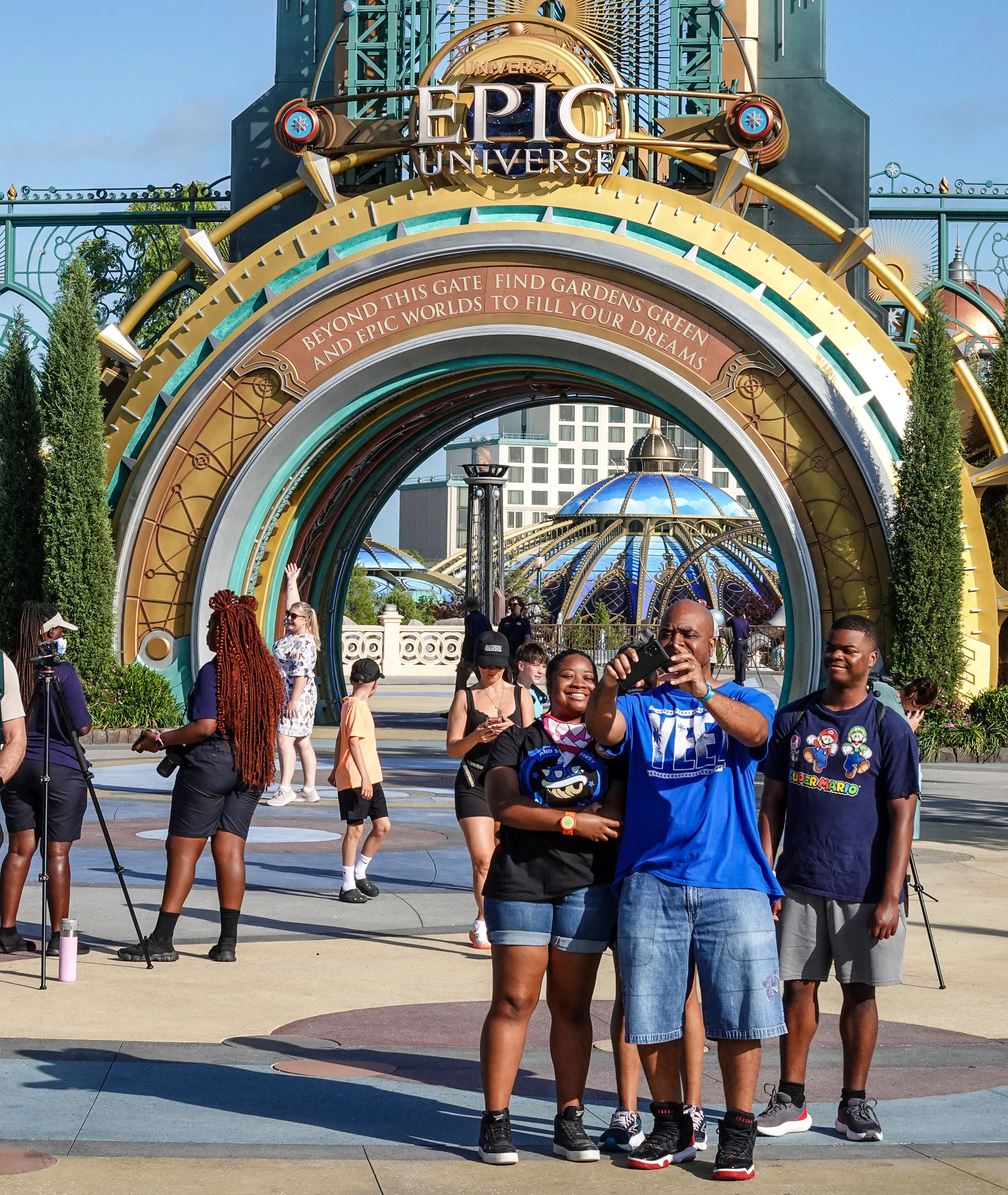 Universal Orlando visitors snap a selfie at the entrance of...