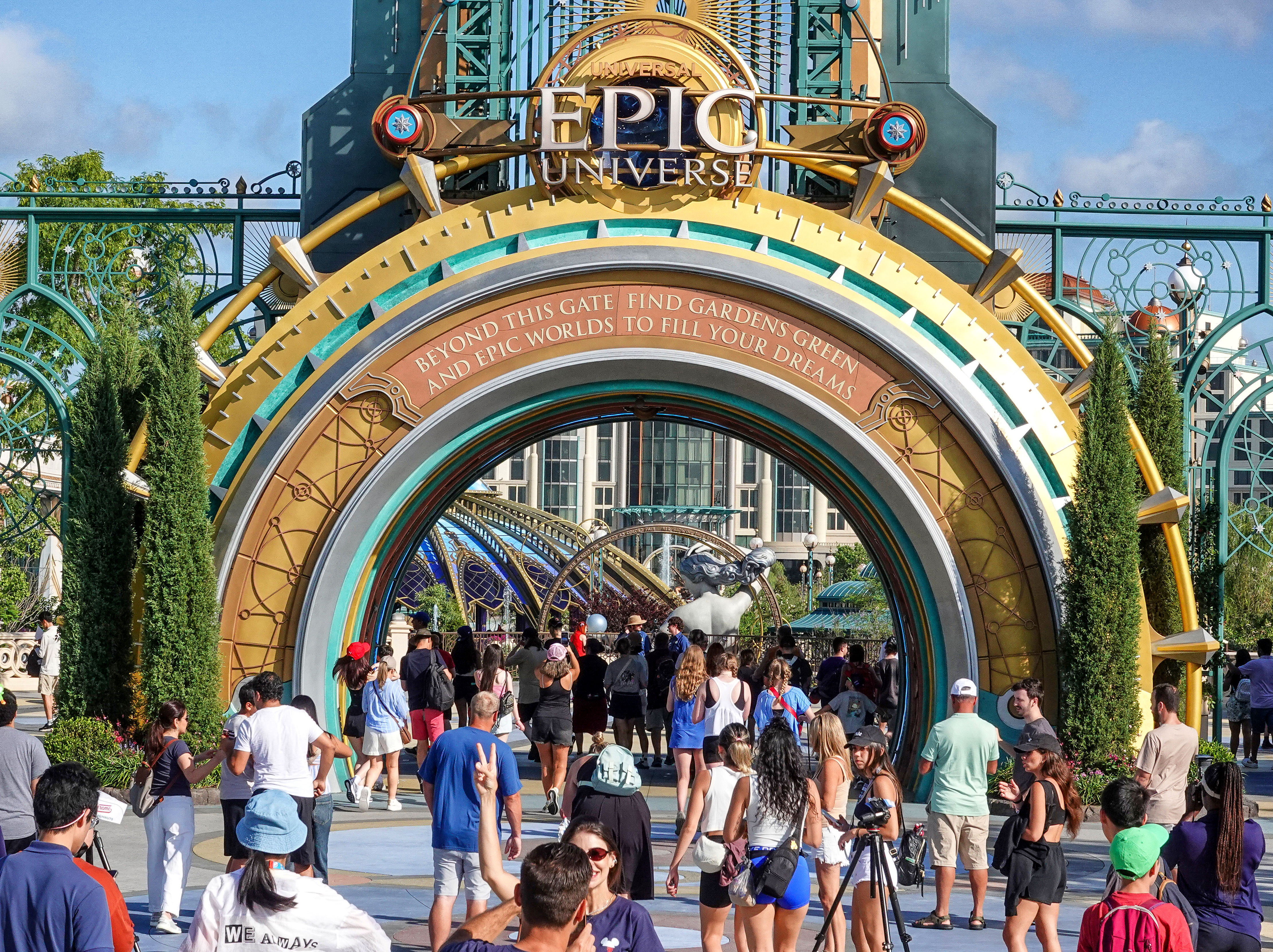 Guests arrive at the entrance of Epic Universe on the...