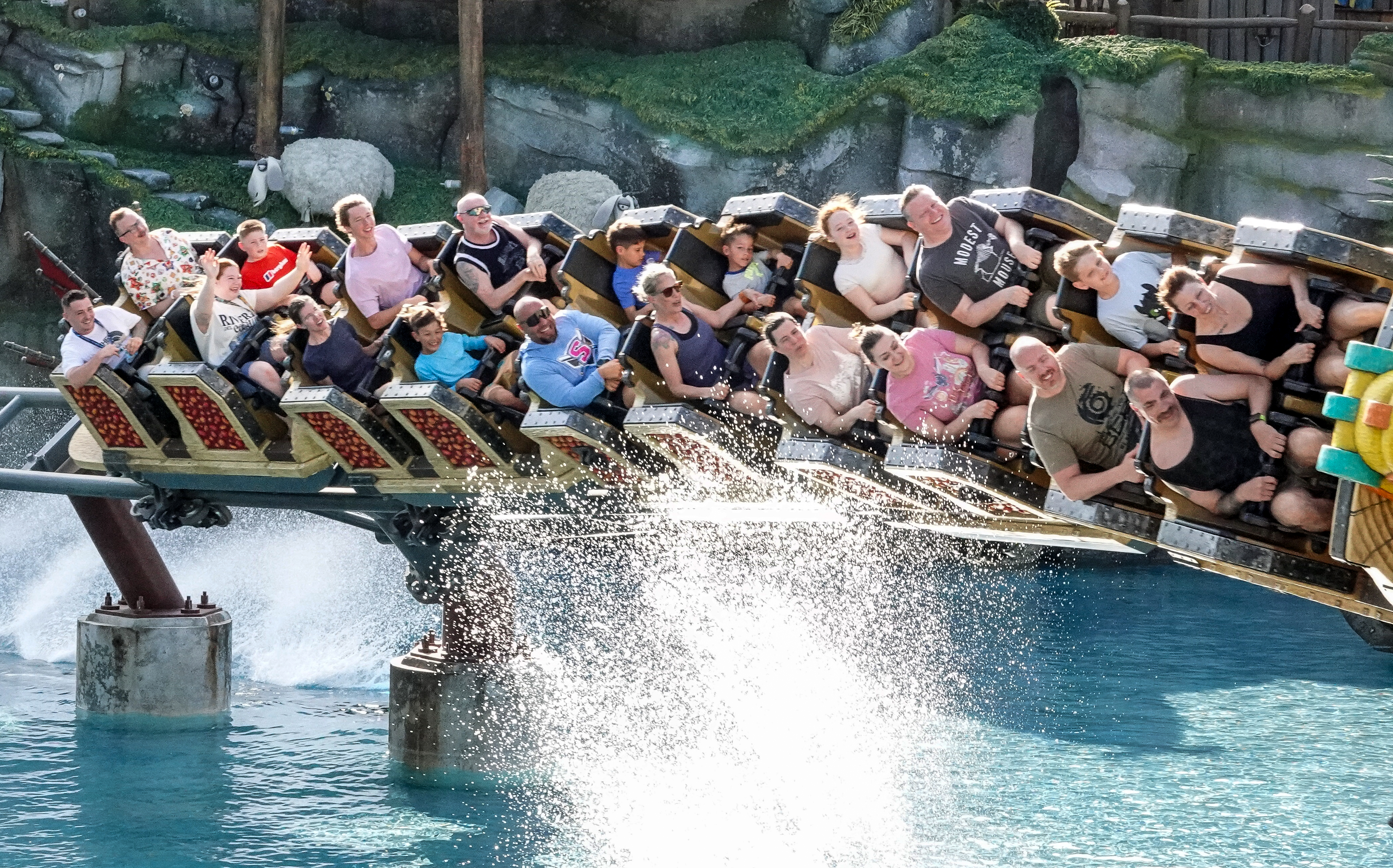 Guests ride the Hiccup's Wing Gliders roller coaster, in the...