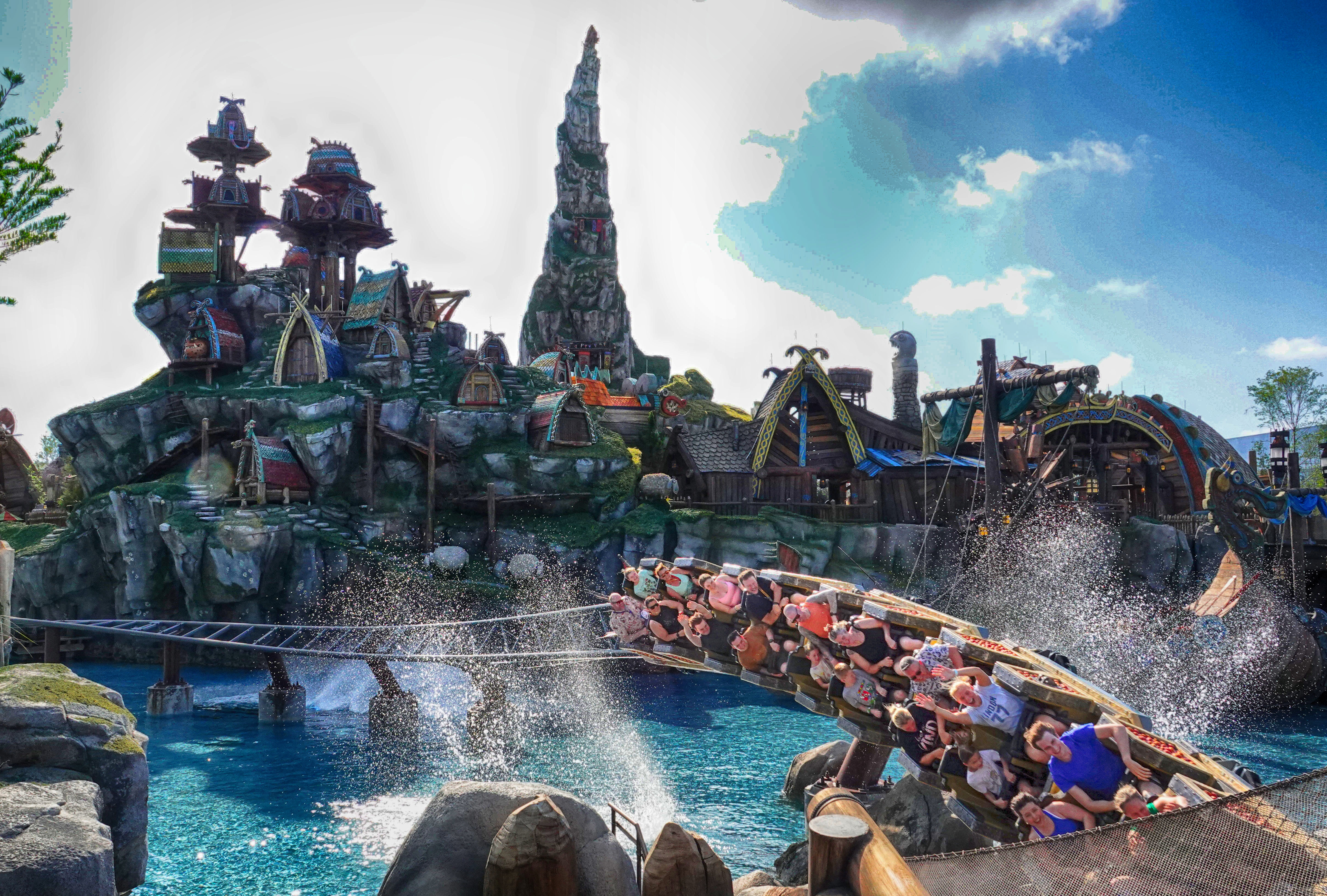 Guests ride the Hiccup's Wing Gliders roller coaster, in the...