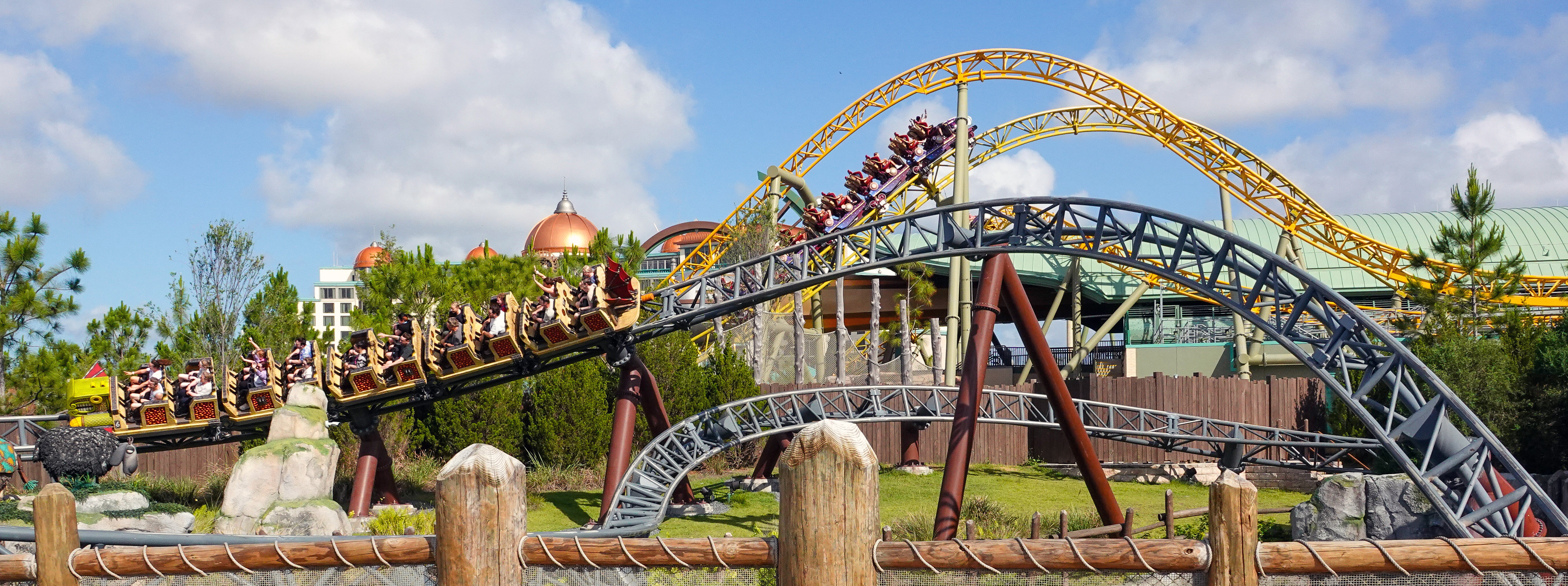 Guests ride the Hiccup's Wing Gliders roller coaster, in the...