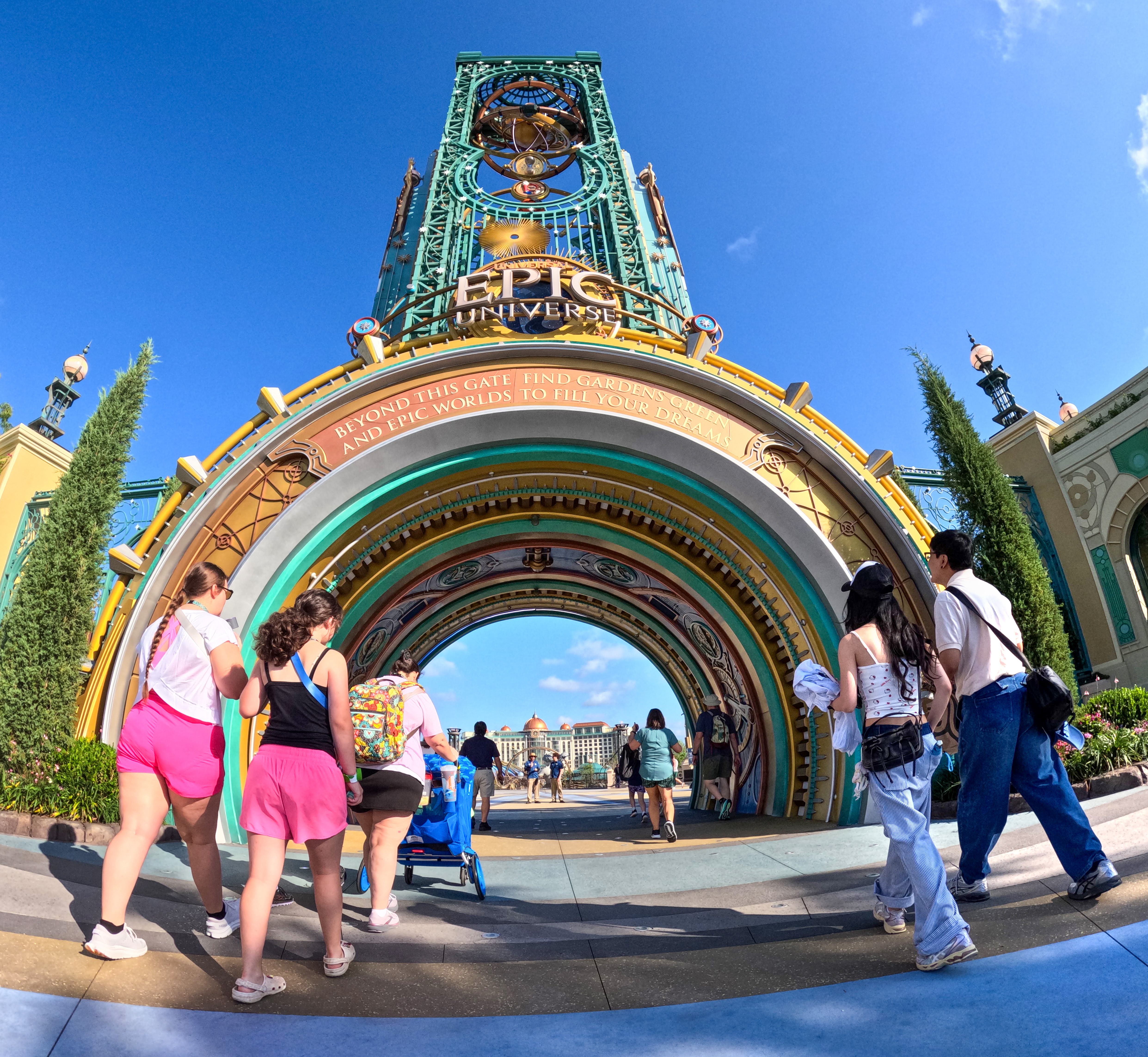 Guests arrive at the entrance of Epic Universe, on the...