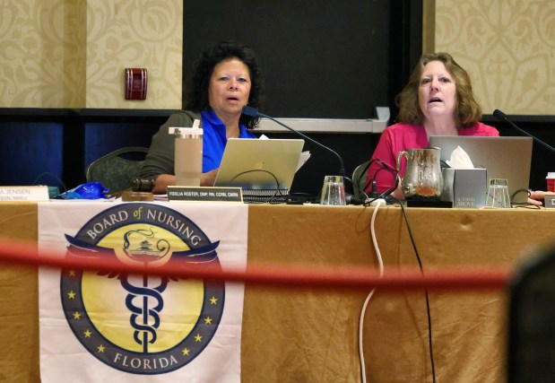 Board member Fidelia Roster and Senior Assistant Attorney General Deborah Loucks, right, listen during the April 2026 Florida Board of Nursing meeting in St. Petersburg. (Joe Burbank/Orlando Sentinel)