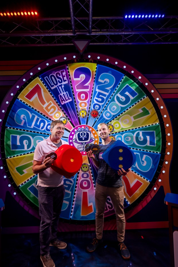 Dewayne Bevil and Patrick Connolly try out the Great Big Game Show, one of the newest attractions on International Drive, which offers mini games that give the feel of being on a TV game show on May 7, 2026. (Patrick Connolly/Orlando Sentinel)