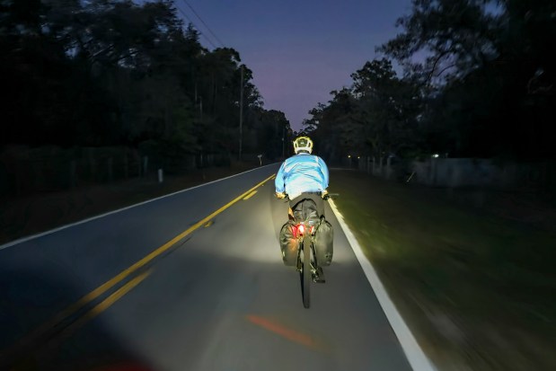 Dusk descends on Evan Sanders while riding into the nighttime during a four-day bikepacking trip on April 15, 2026. (Patrick Connolly/Orlando Sentinel)