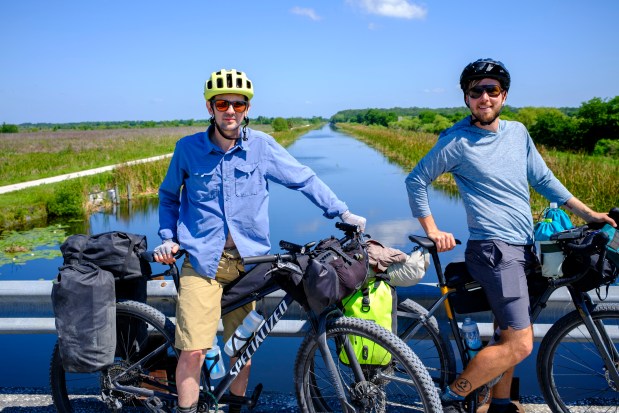 Evan Sanders and Patrick Connolly pause for a photo while exploring the scenic Lake Apopka North Shore along the Huracan bikepacking route on April 17, 2026. (Patrick Connolly/Orlando Sentinel)