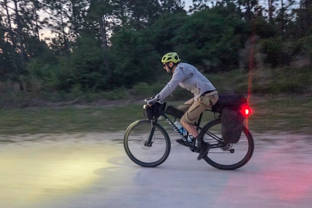 Evan Sanders rides into the sunset on the last day of a Florida bikepacking adventure on April 18, 2026. (Patrick Connolly/Orlando Sentinel)