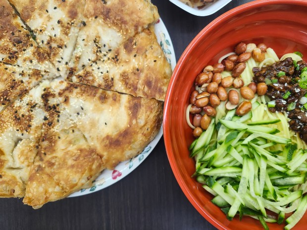 Fresh and fluffy sesame flatbread alongside Beijing-style noodles with soybean paste at TT Crepes in Orlando. (Amy Drew Thompson/Orlando Sentinel)