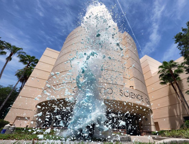 BLOWING BUBBLES WITH SCIENCE Zachary Mailhot, a science program interpreter, gets lost in a geyser of exploding soap suds triggered by liquid nitrogen chilled to -320 degrees Fahrenheit mixed with dish detergent and hot water during a demonstration of "MessFest" experiments at the Orlando Science Center, Wednesday, May 6, 2026. Now in its eighth year, MessFest is a hands-on, science exploration event, May 9 & 10, at the center in Loch Haven Park in Orlando. (Joe Burbank/Orlando Sentinel)
