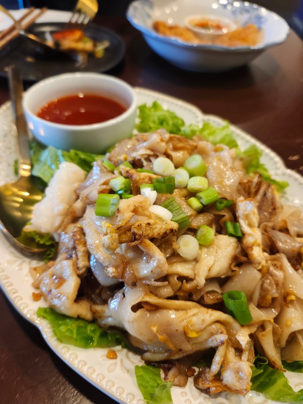 Love Chinese chow fun? Try Thai kua gai at Noods. The rice noodle-centric street food dish, here served with chicken and egg, has an amazing charred flavor. (Amy Drew Thompson/Orlando Sentinel)