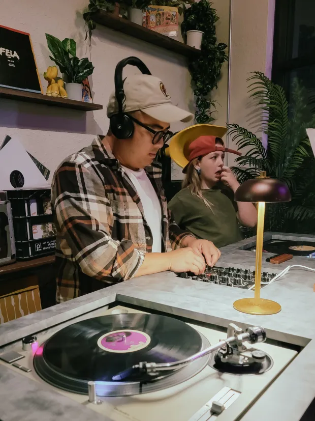 Perla's Pizza owner Michael Collantes often takes a turn behind the turntables on spin nights. (Photo courtesy Lisa Wilk/TasteCookSip.com)