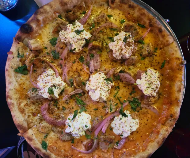 Perla's Pizza's Tikka the Hut gives a nod to India atop flavorful crust that gets a 36-hour cold ferment. (Amy Drew Thompson/Orlando Sentinel)