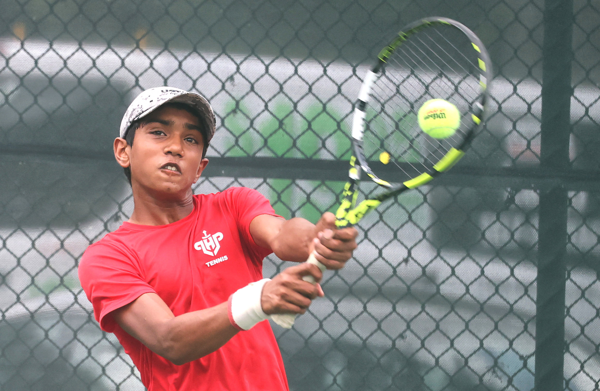 Lake Highland Prepâs Sohith Tella returns a serve at the...