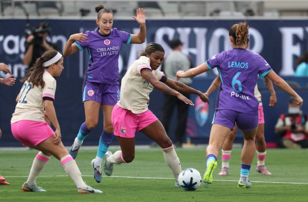 The Wave's Ludmila kicks the ball as Orlando Pride's Ally Lemos, right, runs toward it in the first half at Snapdragon Stadium in San Diego on Sunday, May 24, 2026. (Hayne Palmour IV / For The San Diego Union-Tribune)