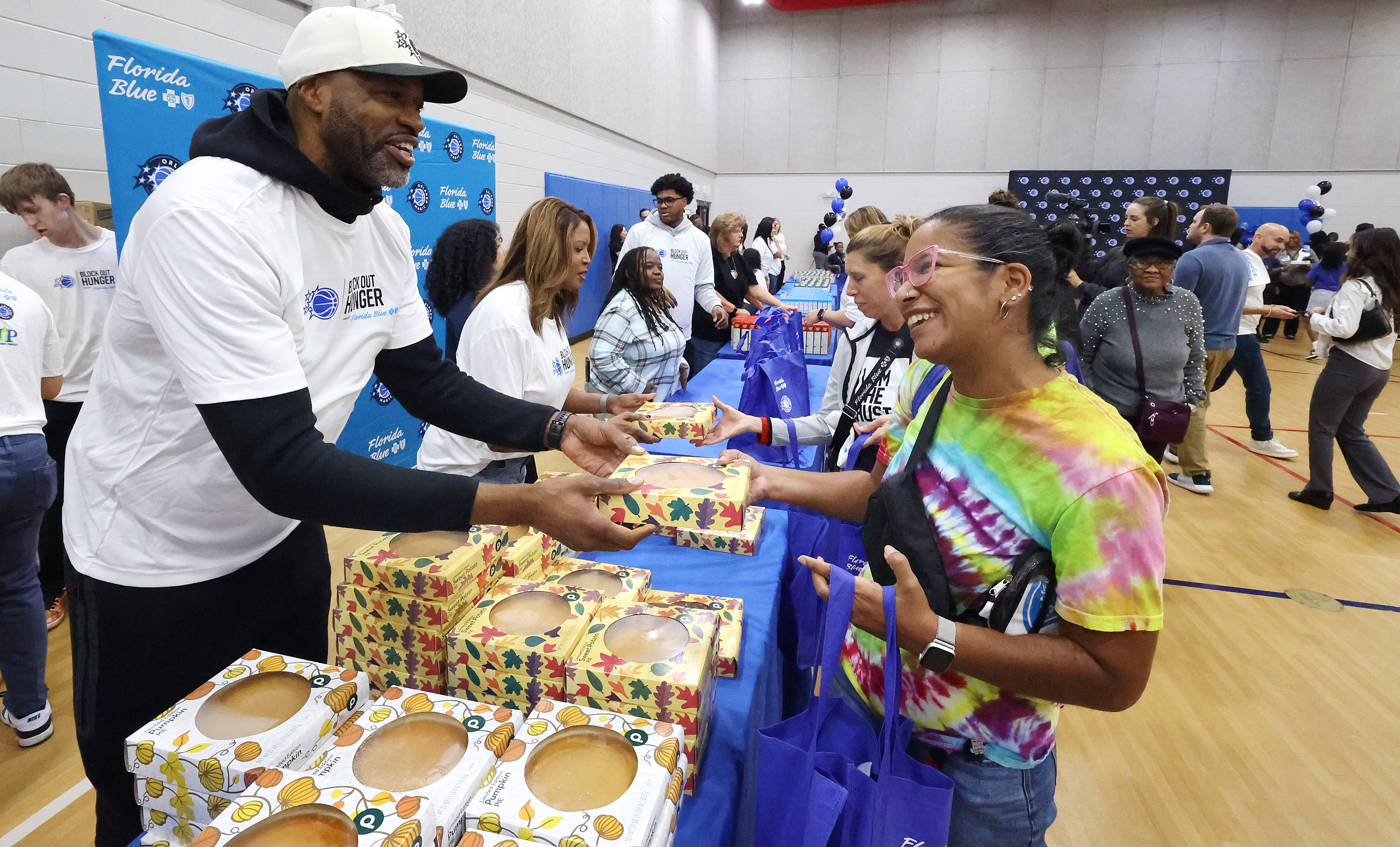 A woman smiles in gratitude as Orlando Magic head coach...