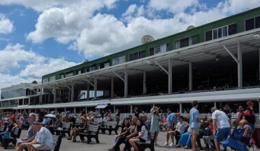 The Tampa Bay Downs’ grandstand is packed with people seated on benches, waiting for the next race. (Photo: ©Tammy A. Gantt)