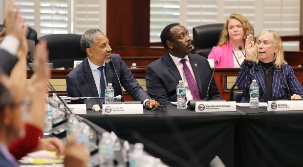 Jane Healy (right) votes "yes" along with others (far left) as Orange County Mayor Jerry Demings (middle) and Tony Jenkins (left of Demings) watch during a meeting of the Orange County Tourist Development Tax (TDT) Citizen Advisory Task Force at the Orange County Administration Building in Orlando on Monday, June 26, 2023. The goal of this task force is to review and provide input to the Board of County Commissioners and Tourist Development Council on potential uses of future, unencumbered TDT revenues.(Stephen M. Dowell/Orlando Sentinel)User Upload Caption: