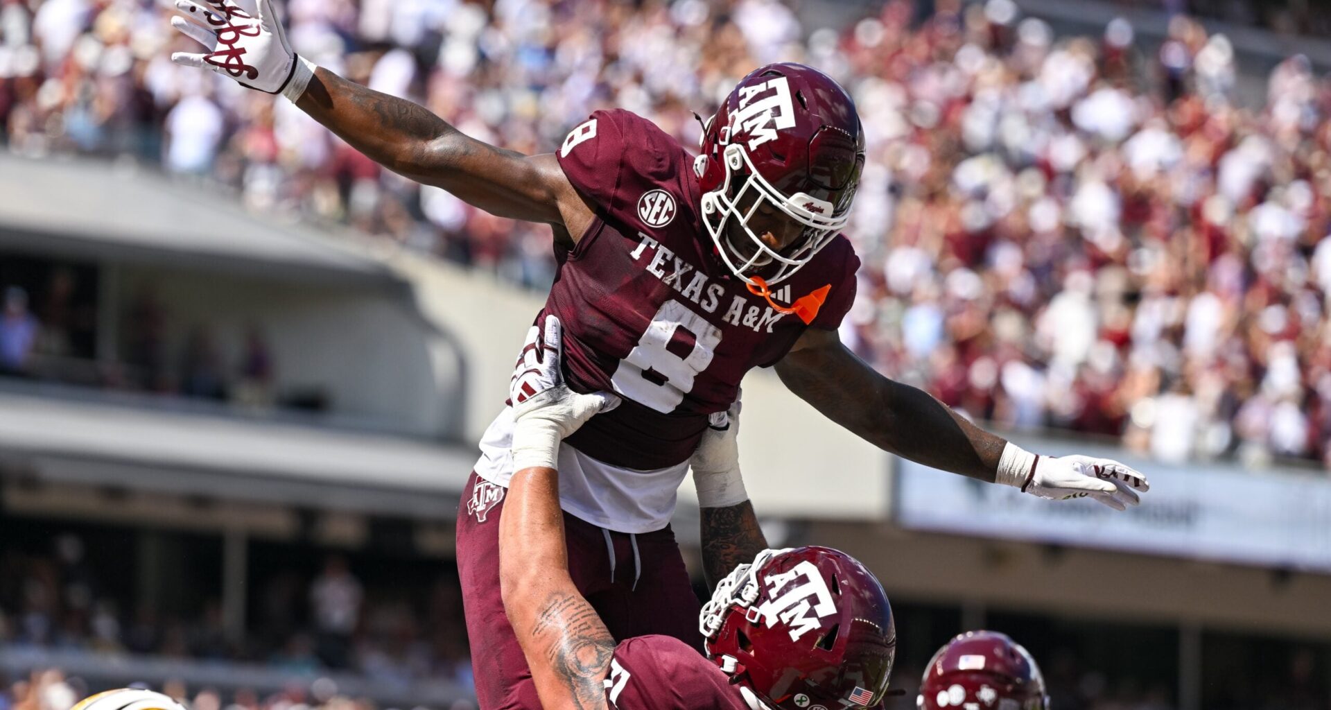 Oct 5, 2024; College Station, Texas, USA; Texas A&M Aggies running back Le'Veon Moss (8) celebrates with offensive lineman Chase Bisontis (71) after scoring a touchdown in the second quarter against the Missouri Tigers at Kyle Field. Mandatory Credit: Maria Lysaker-Imagn Images.