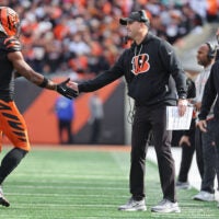 Oct 26, 2025; Cincinnati, Ohio, USA; Cincinnati Bengals wide receiver Ja'Marr Chase (1) shakes hands with head coach Zac Taylor during the fourth quarter against the New York Jets at Paycor Stadium.