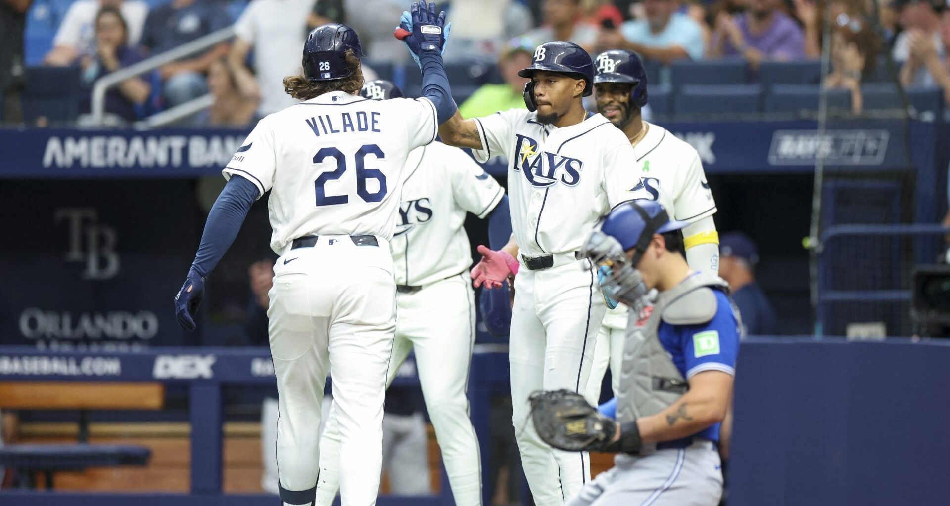 May 4, 2026; St. Petersburg, Florida, USA; Tampa Bay Rays left fielder Chandler Simpson (14) greets right fielder Ryan Vilade (26) at home plate after hitting a three-run home run against the Toronto Blue Jays in the first inning at Tropicana Field.