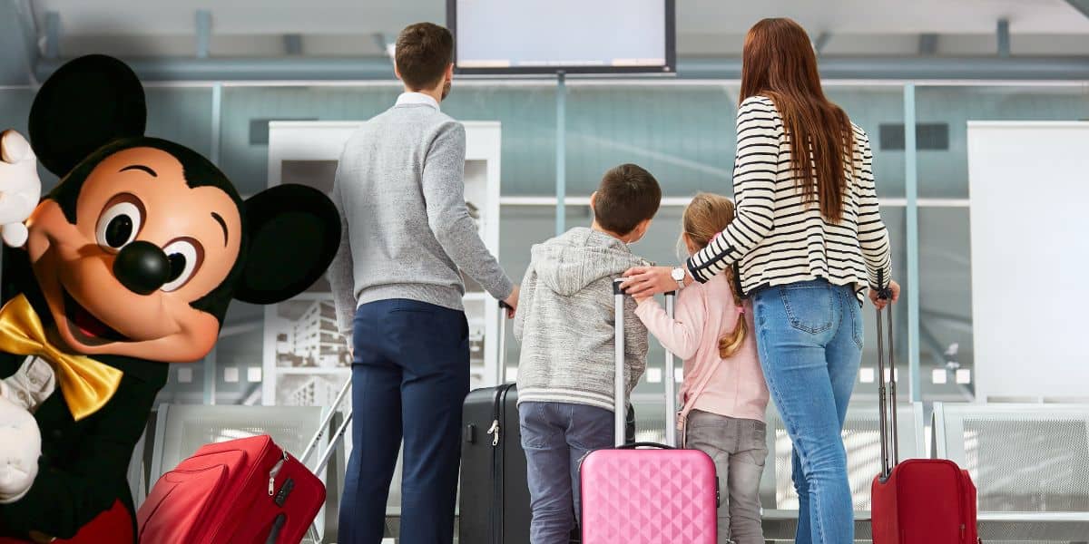 A family with suitcases checks an airport screen as Mickey Mouse welcomes them, hinting at an exciting Disney World adventure. Global Entry shutdown Disney travel. Orlando to Tokyo Disney Resort flights