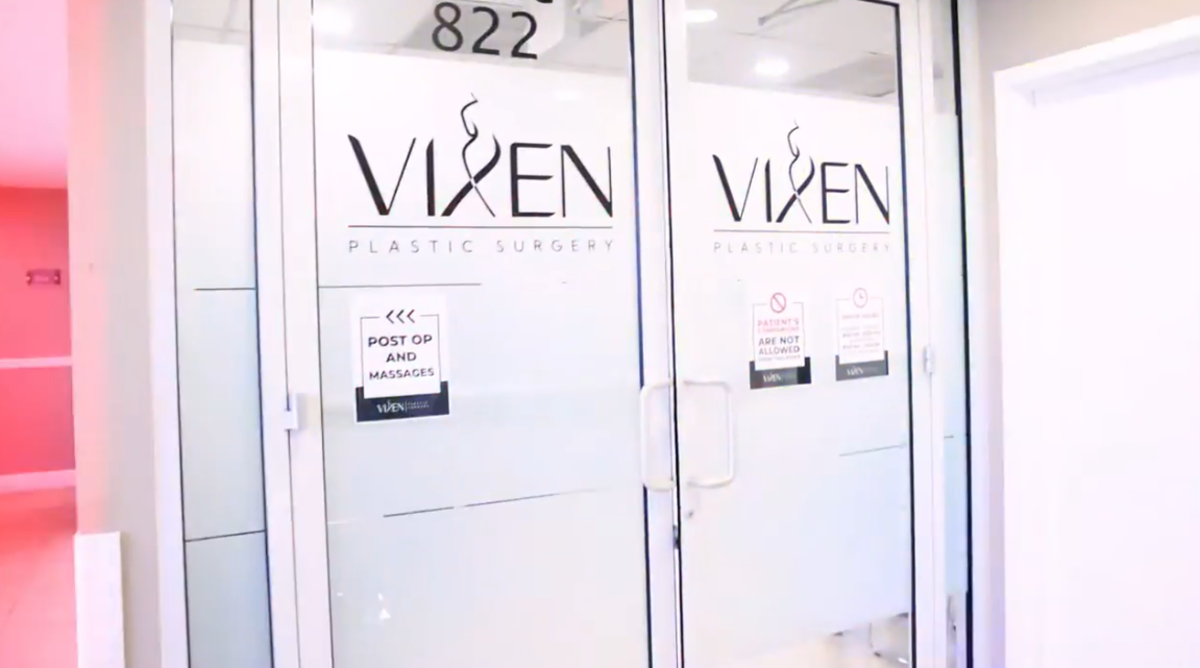 A screenshot from a YouTube video of doors to a plastic surgery clinic that read "VIXEN"