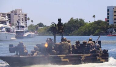 Military personnel conduct a tactical boat demonstration on the Hillsborough River during SOF Week in Tampa.