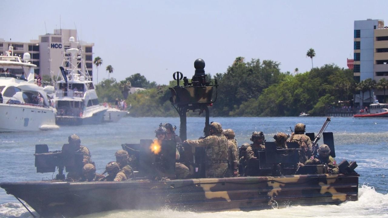 Military personnel conduct a tactical boat demonstration on the Hillsborough River during SOF Week in Tampa.