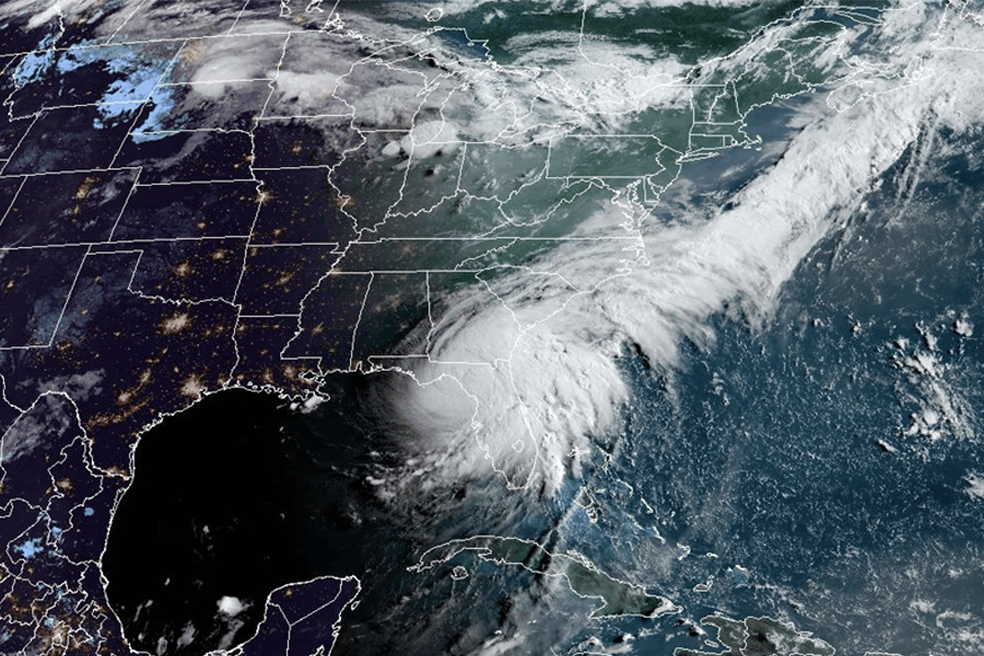 A satellite image showing a hurricane over Florida. State boundaries are displayed in white, and cities are illuminated in yellow.
