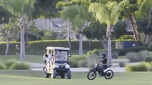 Teens riding on motorized bikes through a golf course in Florida.