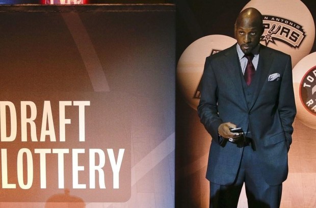Miami Heat Vice President Alonzo Mourning checks his cell phone before the 2015 NBA draft lottery, Tuesday, May 19, 2015, in New York. (AP Photo/Julie Jacobson)