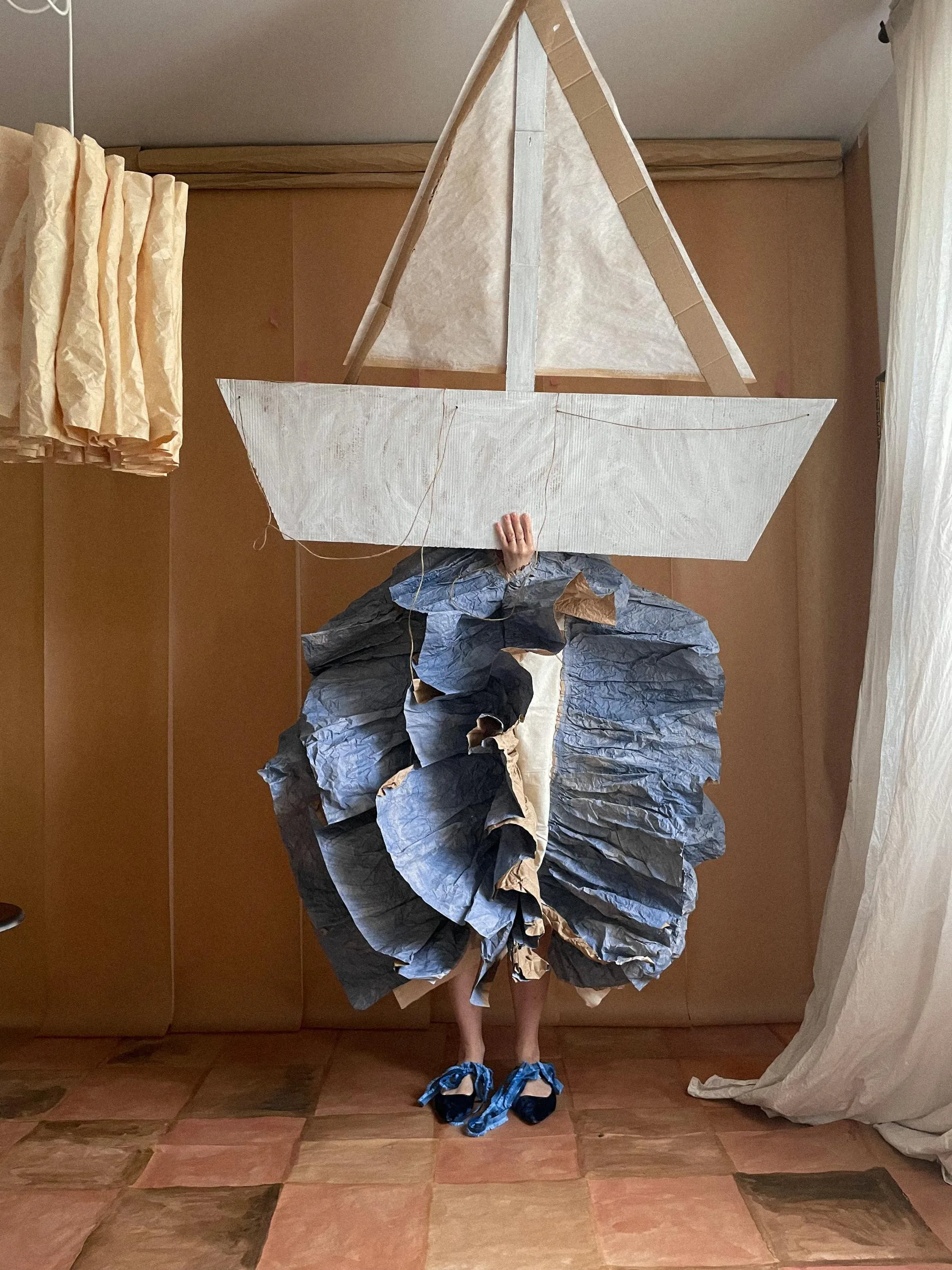 Alla's Nocturnal Visions: Transforming Sheets of Paper into Enchanting Wearable Worlds in St. Petersburg Artistic arrangement of paper sculptures innovatively displayed in the space.
