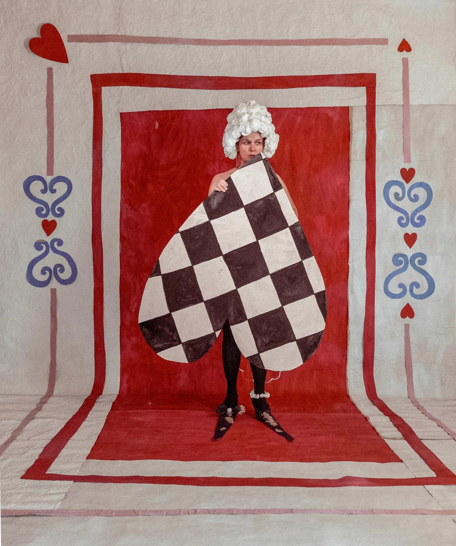 Alla's Nocturnal Visions: Transforming Sheets of Paper into Enchanting Wearable Worlds in St. Petersburg An artist assembling paper elements into a complex wearable piece.