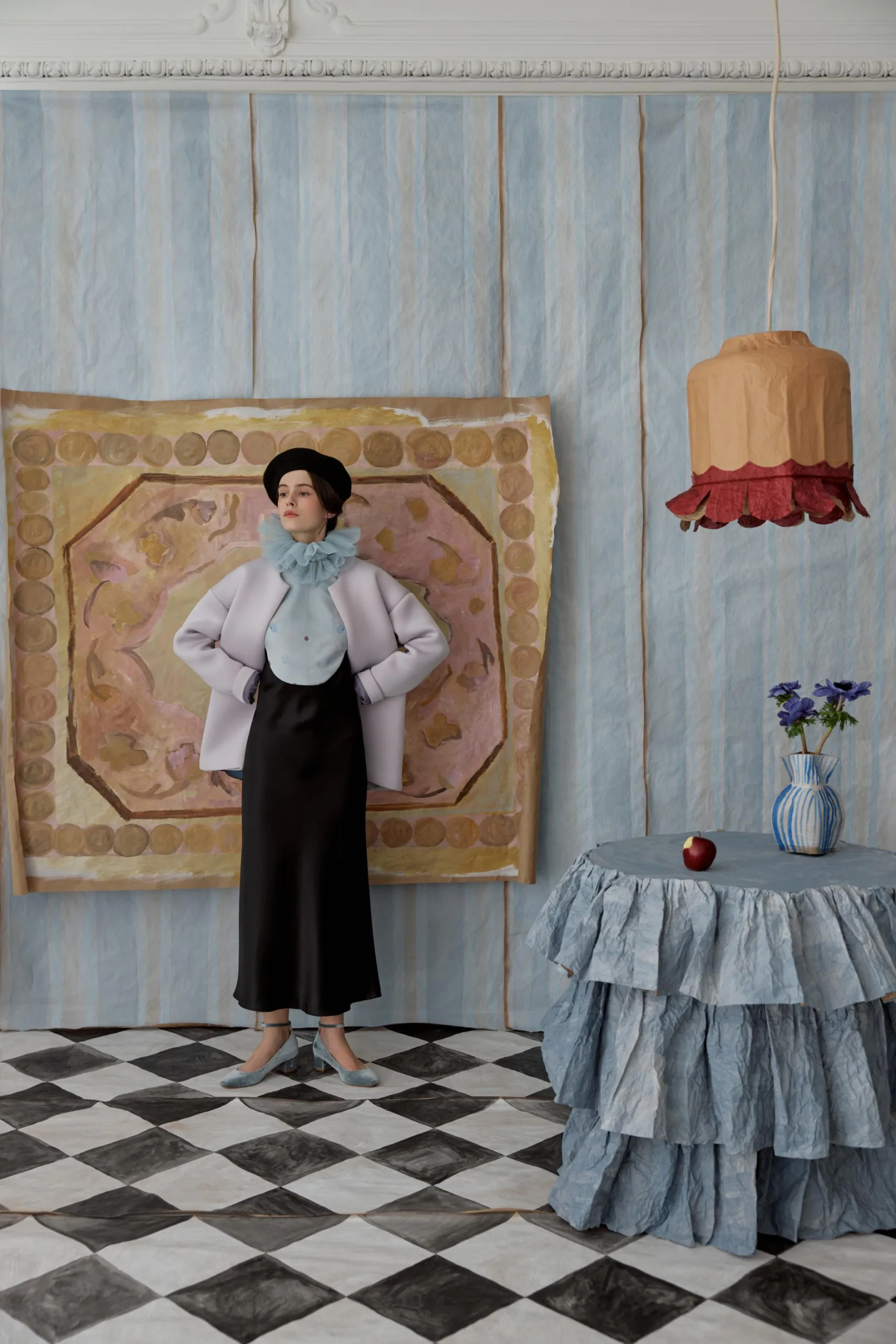 Alla's Nocturnal Visions: Transforming Sheets of Paper into Enchanting Wearable Worlds in St. Petersburg A model stands against a backdrop, showcasing a stunning paper outfit.