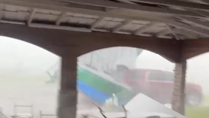 Nasty weather in Florida sends a bounce house tumbling through a backyard.